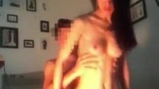 Chinese couple filming in room having fun