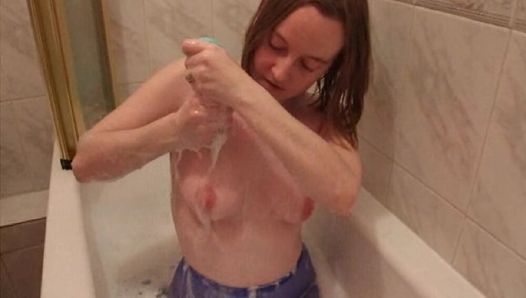 Wife washing small breasts in blue pantyhose