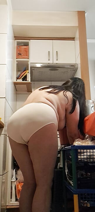 Mature milf in the kitchen cooking for stepson